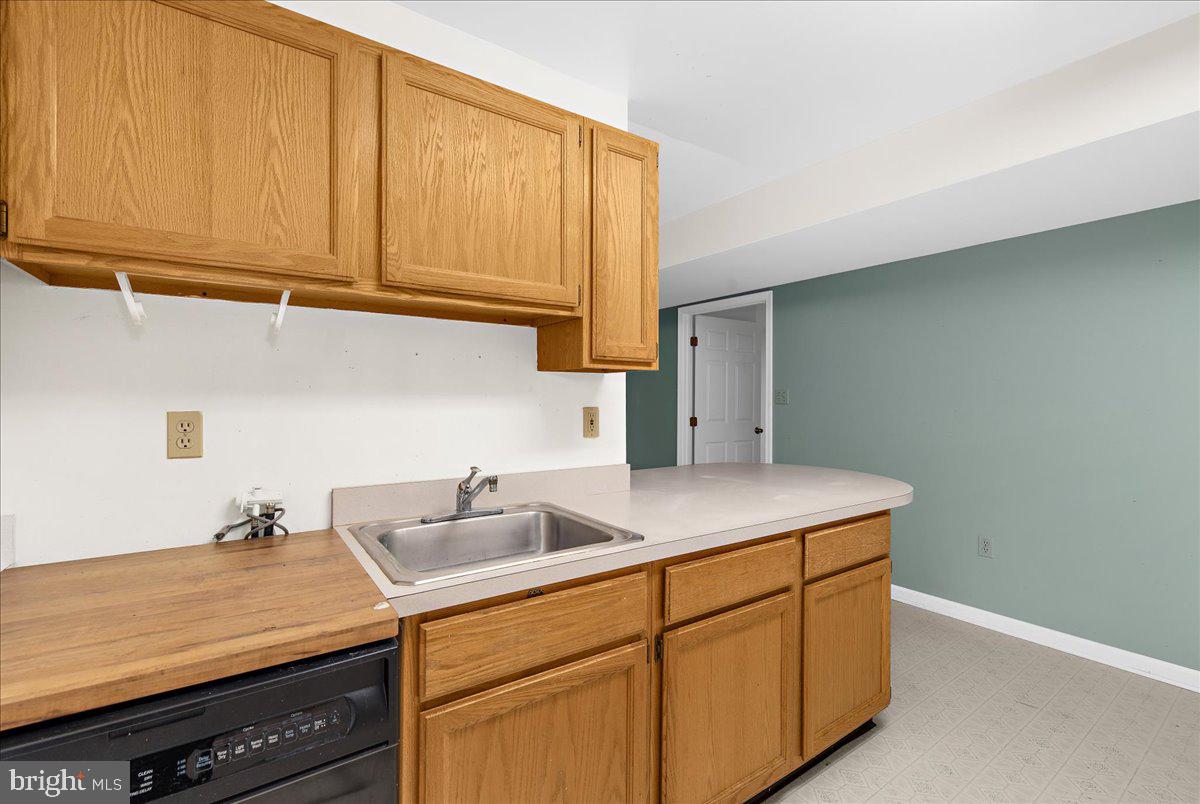 5789 Greenock Road Lothian, MD 20711 - Photo 45 of 57 a kitchen with a sink cabinets and utility