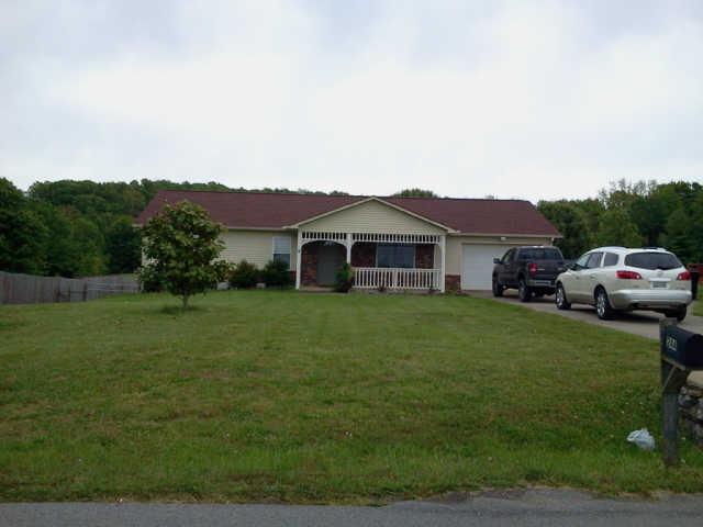 244 Hester Road Portland, TN 37148 - Photo 2 of 13 a front view of a house with a garden