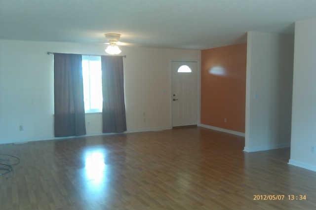 244 Hester Road Portland, TN 37148 - Photo 3 of 13 a view of an empty room with wooden floor and a window