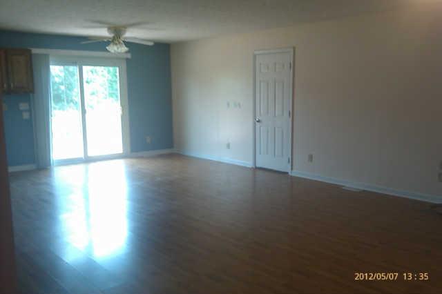 244 Hester Road Portland, TN 37148 - Photo 4 of 13 an empty room with wooden floor and windows