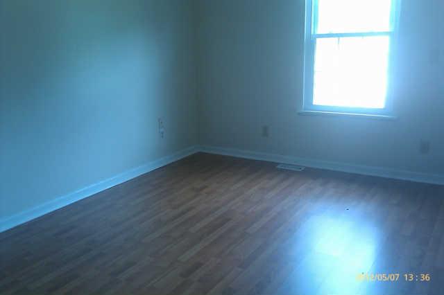 244 Hester Road Portland, TN 37148 - Photo 7 of 13 an empty room with wooden floor and windows