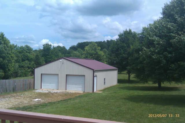 244 Hester Road Portland, TN 37148 - Photo 10 of 13 a house with trees in the background