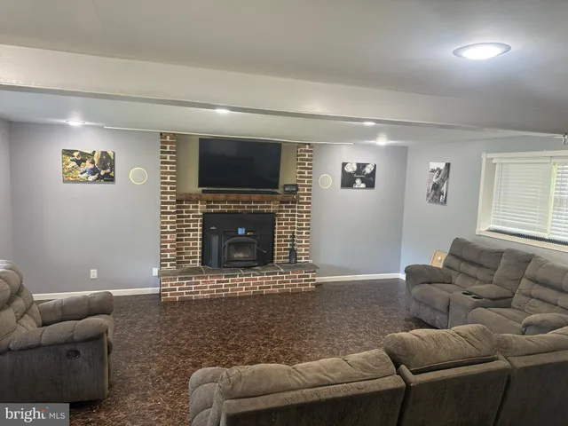 a view of a room with wooden floor and window