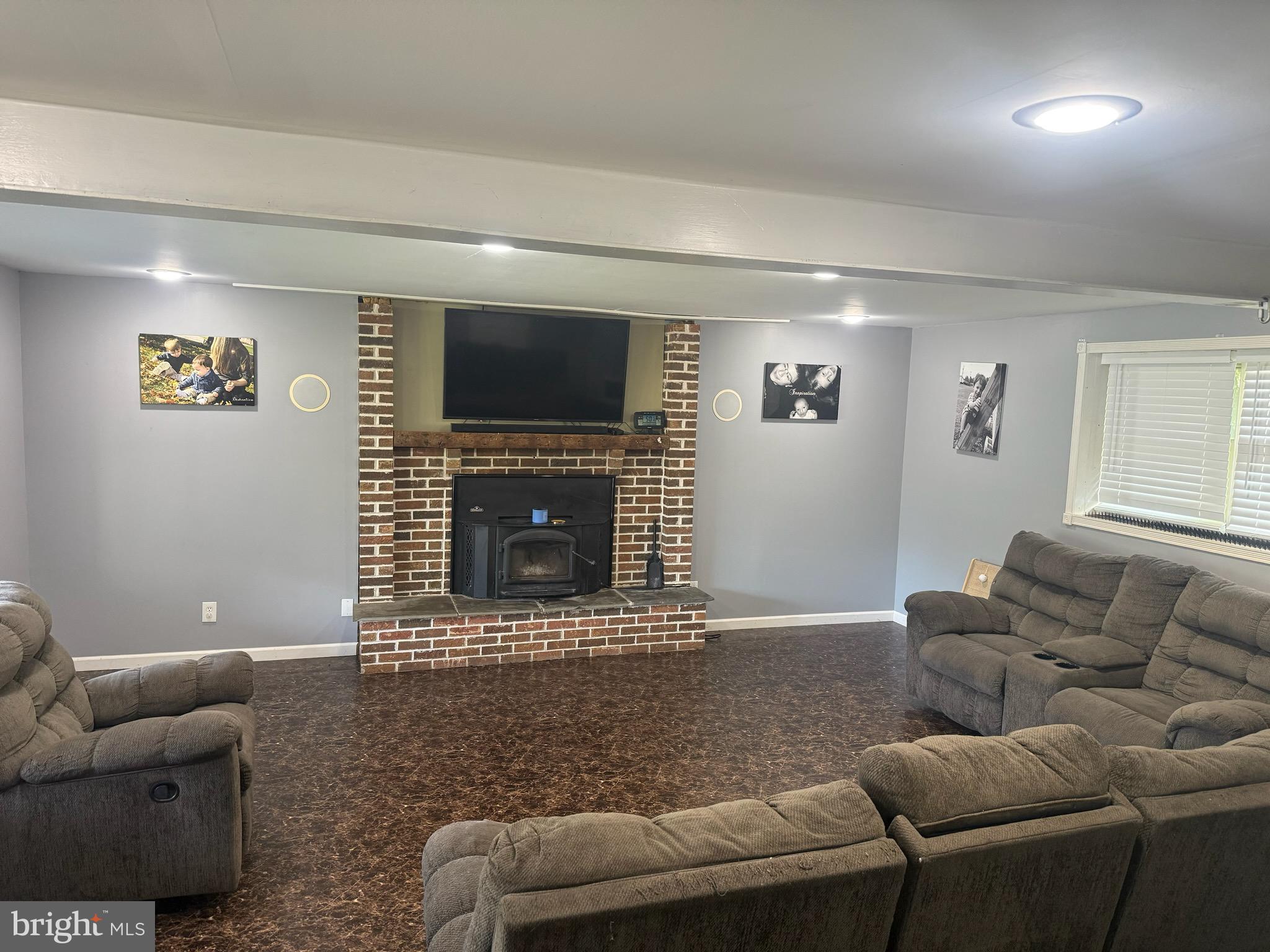 65 Campbell Road York, PA 17406 - Photo 19 of 61 a living room with furniture a flat screen tv and a fireplace