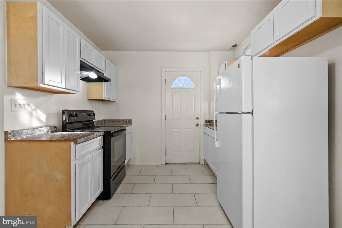 6416 Blair Road Northwest Washington, DC 20012 - Photo 11 of 32 a kitchen with a refrigerator and a stove