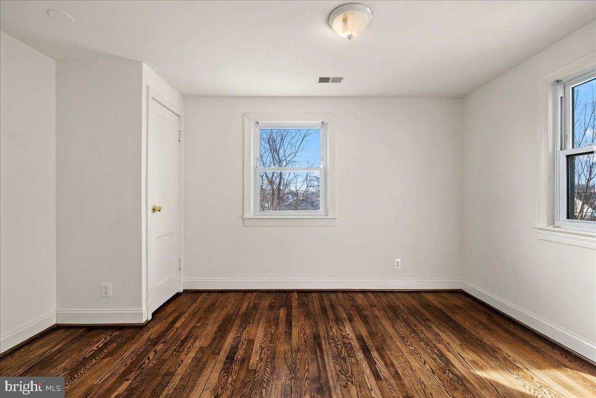 6416 Blair Road Northwest Washington, DC 20012 - Photo 13 of 32 an empty room with wooden floor and windows