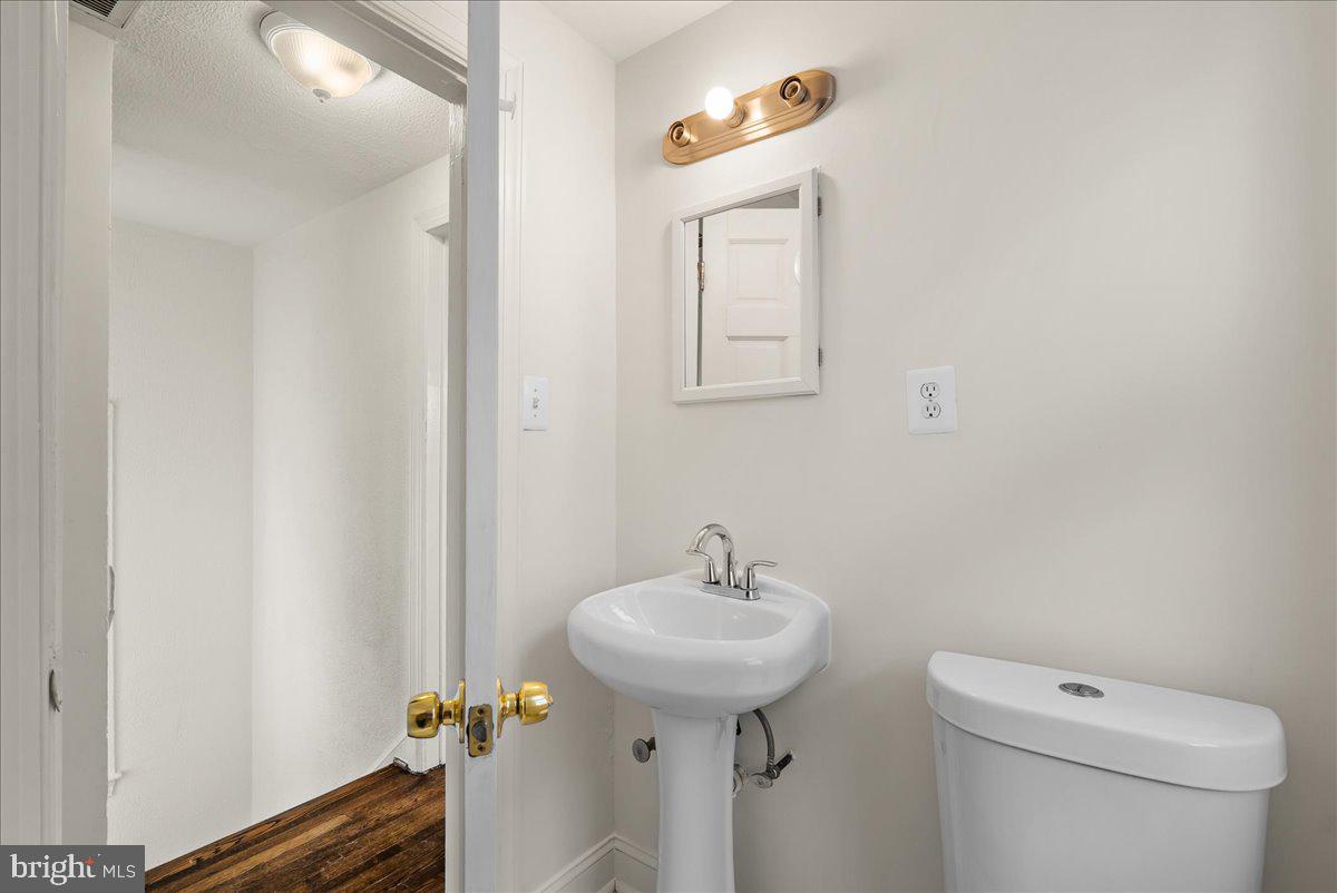 6416 Blair Road Northwest Washington, DC 20012 - Photo 16 of 32 a bathroom with a sink toilet and mirror