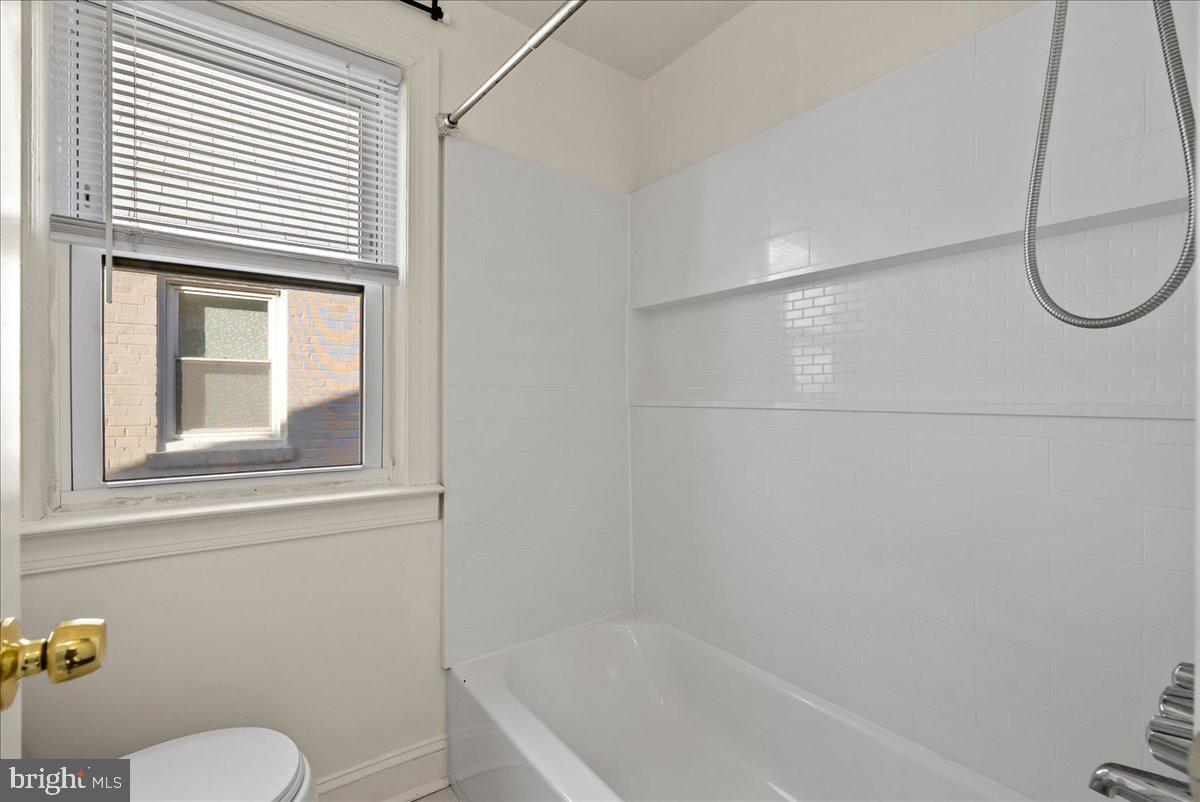 6416 Blair Road Northwest Washington, DC 20012 - Photo 17 of 32 a bathroom with a bath tub a toilet and a shower