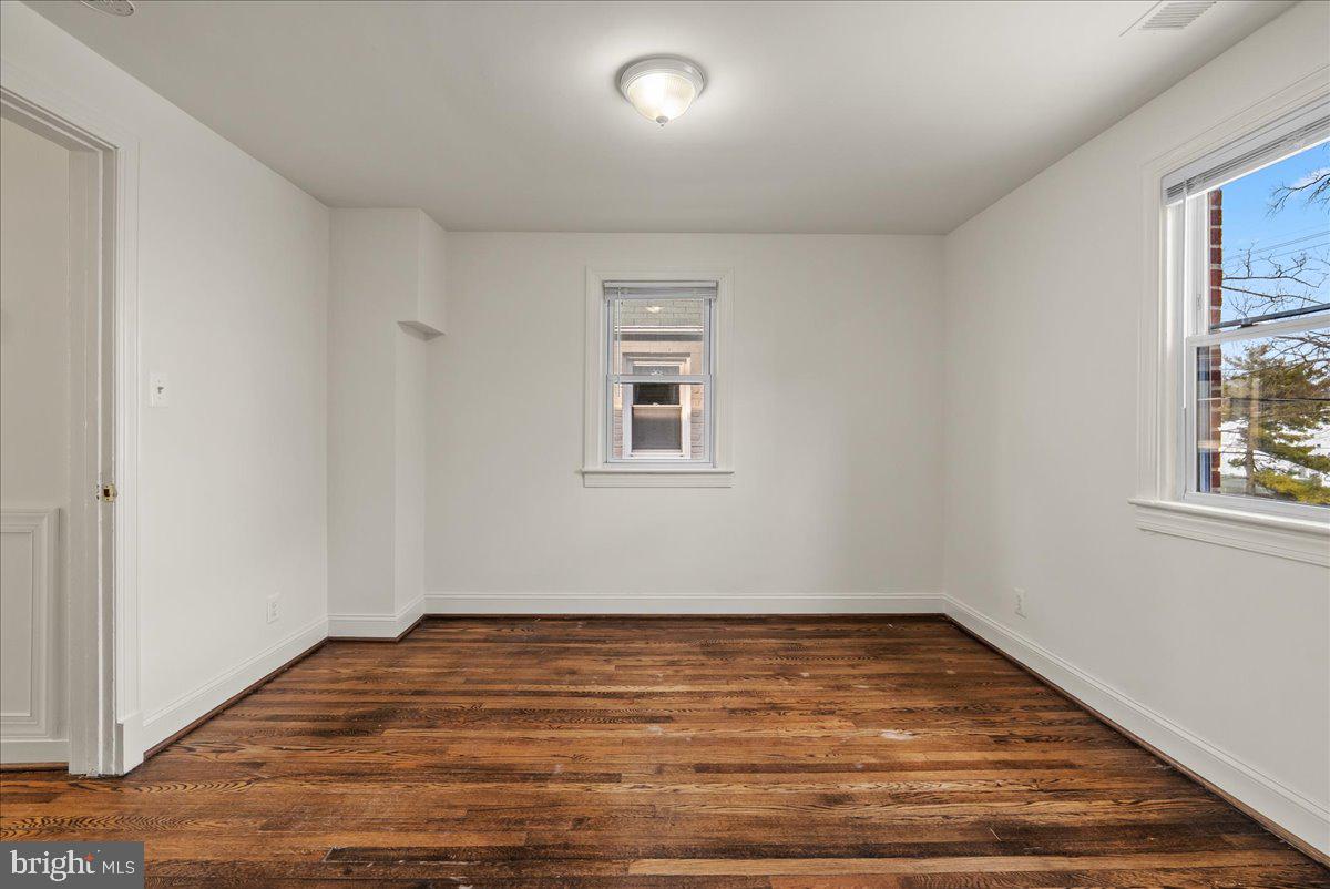 6416 Blair Road Northwest Washington, DC 20012 - Photo 20 of 32 a view of empty room with wooden floor and fan