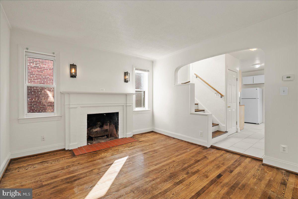 6416 Blair Road Northwest Washington, DC 20012 - Photo 4 of 32 a view of empty room with wooden floor and fireplace