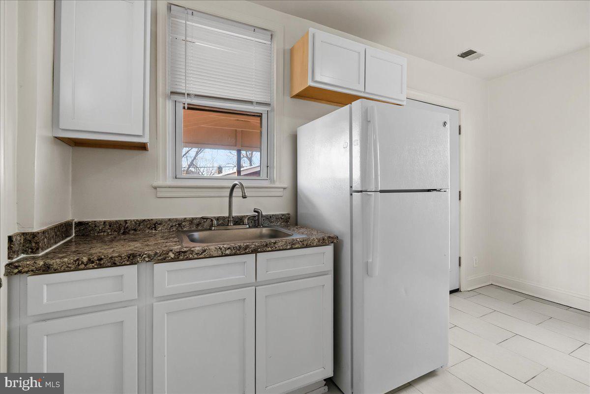 6416 Blair Road Northwest Washington, DC 20012 - Photo 9 of 32 a kitchen with appliances cabinets and a sink