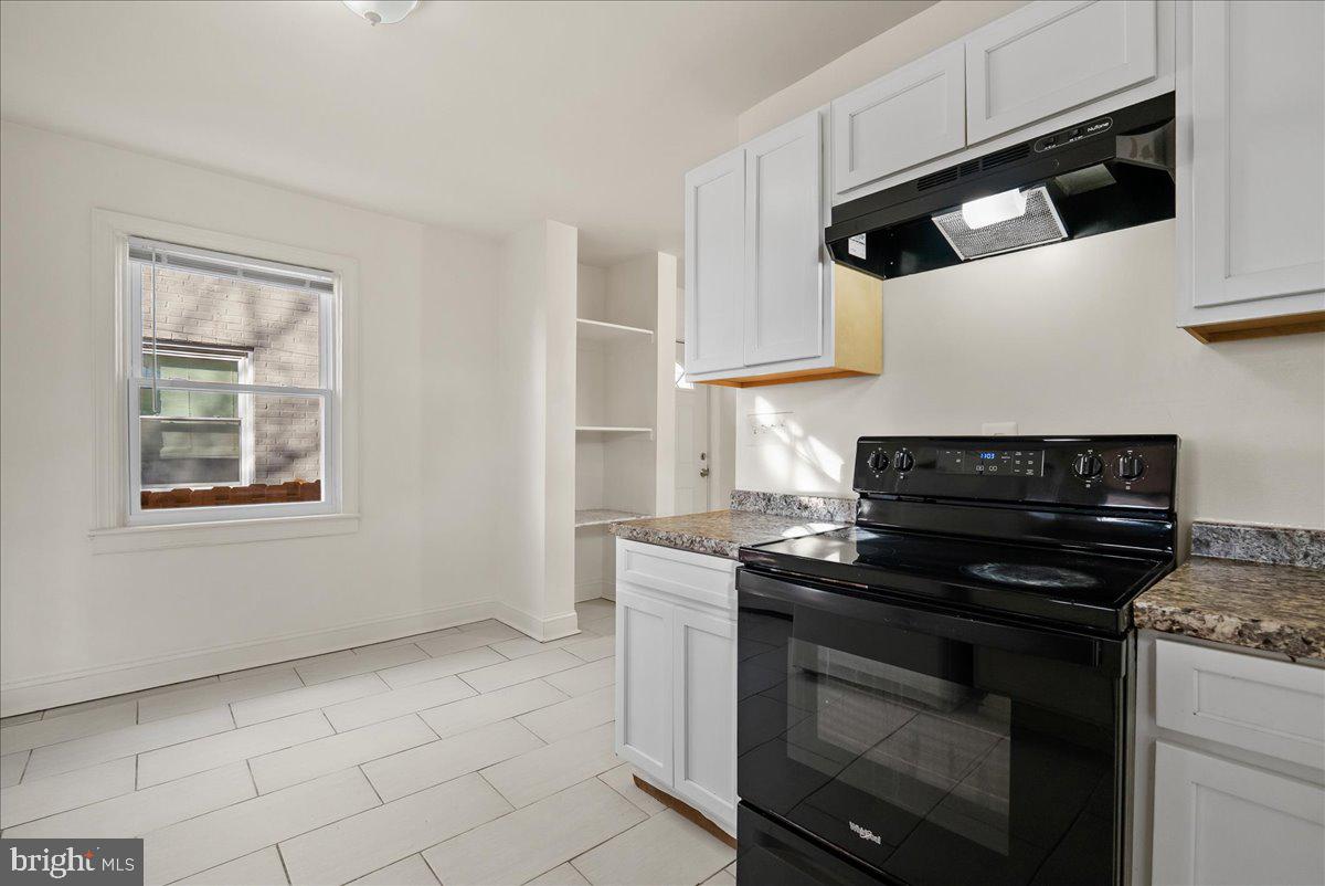 6416 Blair Road Northwest Washington, DC 20012 - Photo 10 of 32 a kitchen with white cabinets and appliances