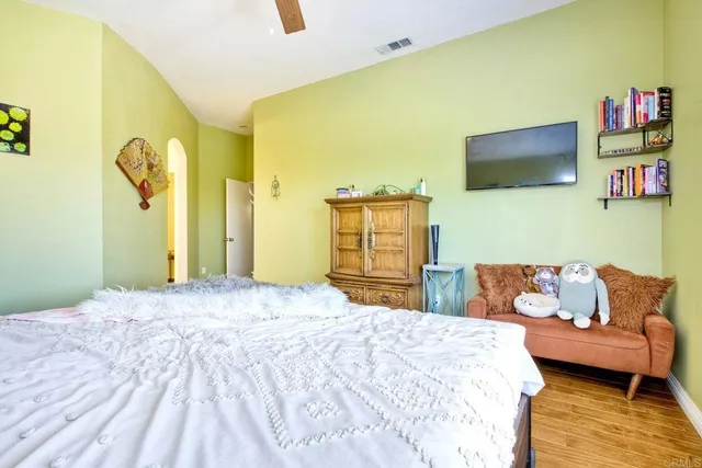 a bedroom with a bed and a flat screen tv