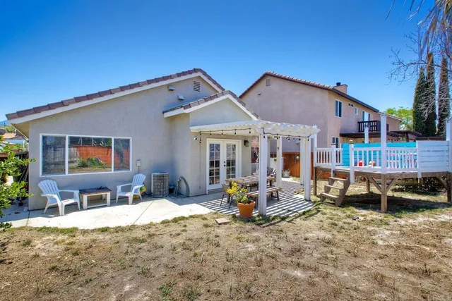 a patio with sofas fire pit table and chairs