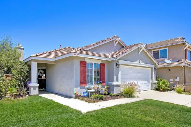 front view of a house with potted plants