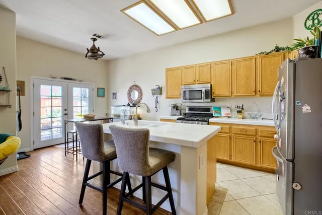 a kitchen with a table chairs refrigerator and microwave