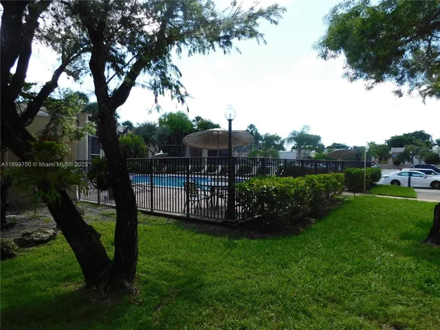 a view of living room with furniture and a fireplace