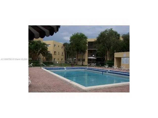 a view of a water pond with green yard