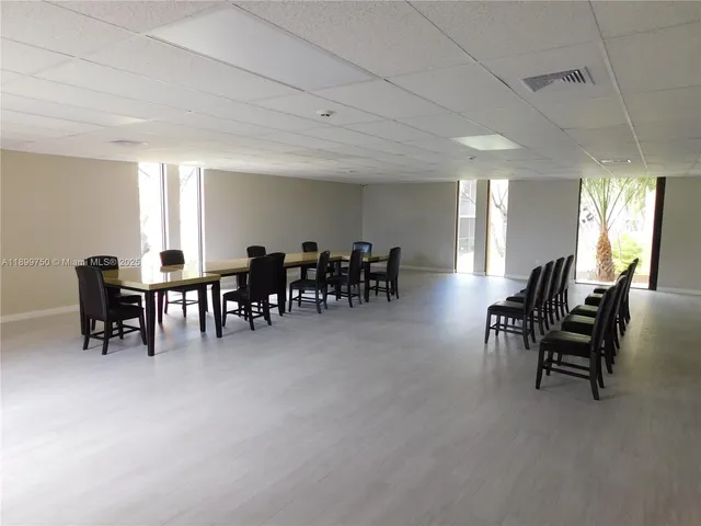 a living room with furniture and paintings on the wall