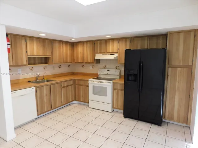 a kitchen with a white cabinets and white appliances