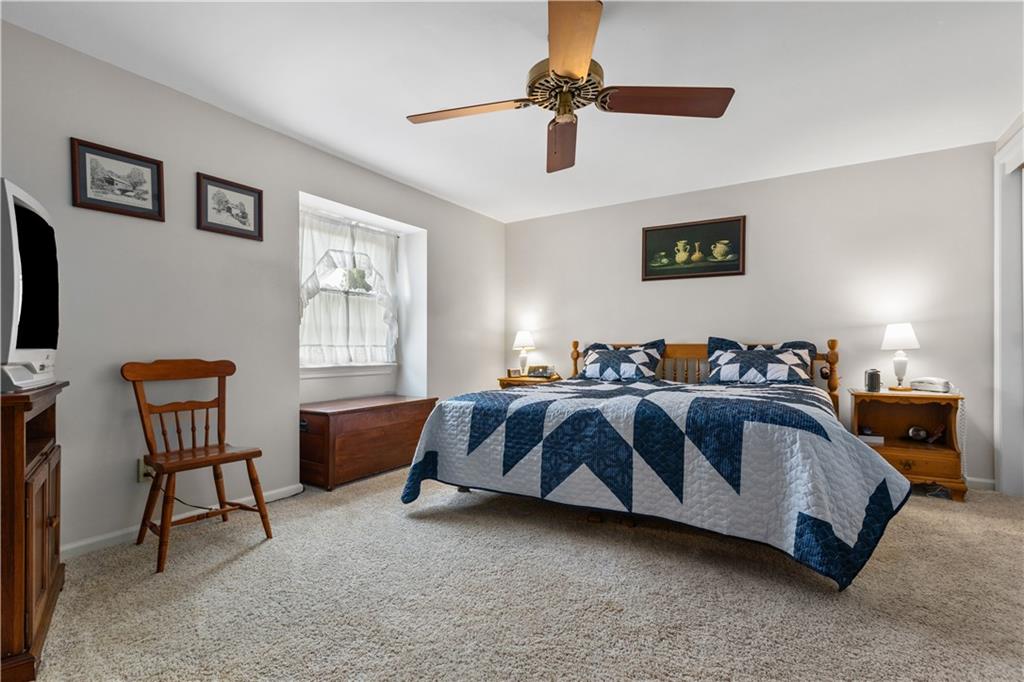 5895 Tuscarawas Road Beaver, PA 15009 - Photo 15 of 23 a spacious bedroom with a bed and a chandelier