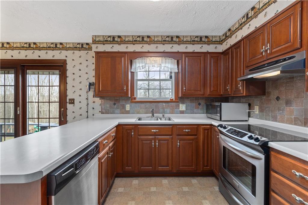 5895 Tuscarawas Road Beaver, PA 15009 - Photo 6 of 23 a kitchen with a sink stove and cabinets