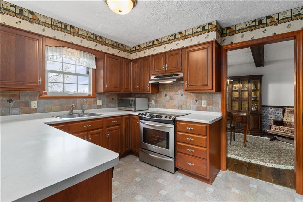 5895 Tuscarawas Road Beaver, PA 15009 - Photo 8 of 23 a kitchen with stainless steel appliances granite countertop a sink stove and refrigerator