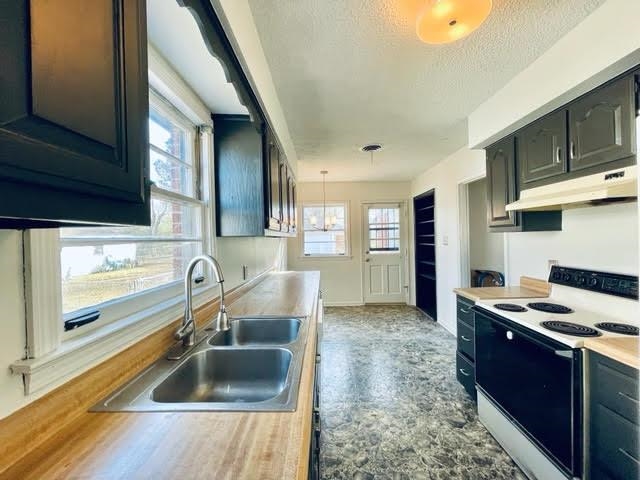 4691 Lynn Road Memphis, TN 38122 - Photo 3 of 12 a kitchen with granite countertop a sink stove and cabinets
