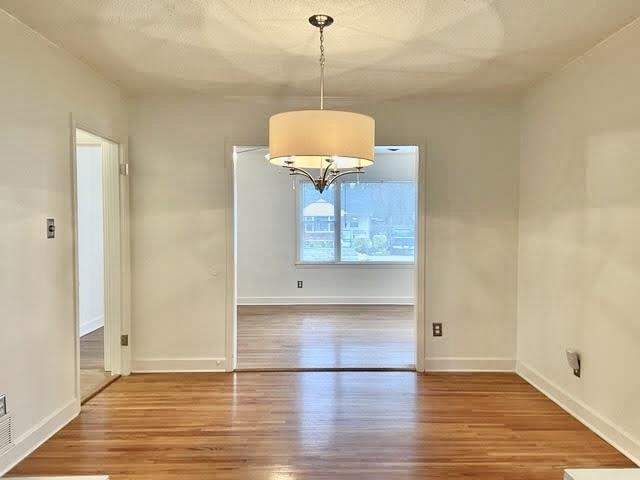 4691 Lynn Road Memphis, TN 38122 - Photo 5 of 12 an empty room with wooden floor and windows