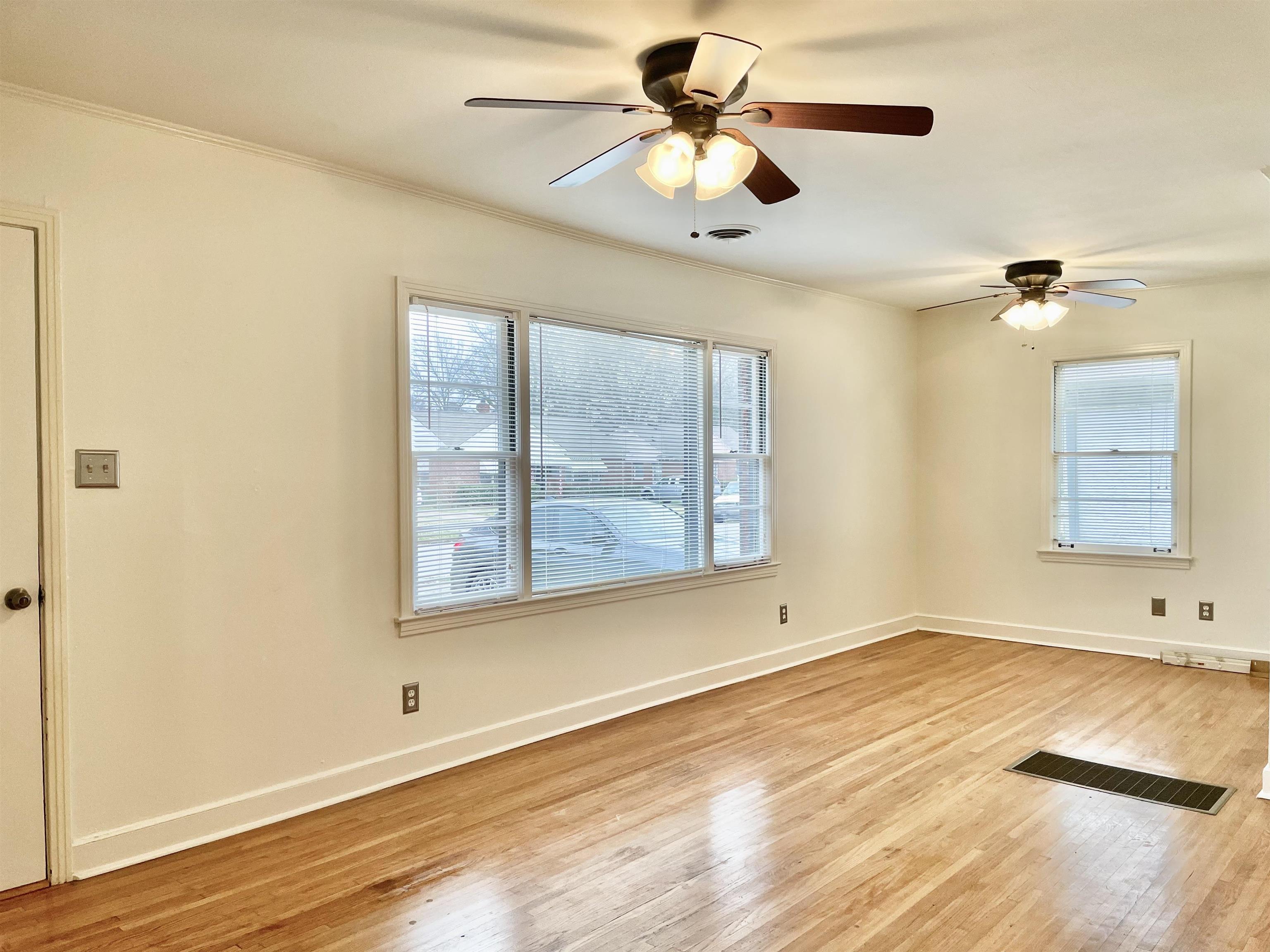4691 Lynn Road Memphis, TN 38122 - Photo 6 of 12 a view of an empty room with wooden floor and a window