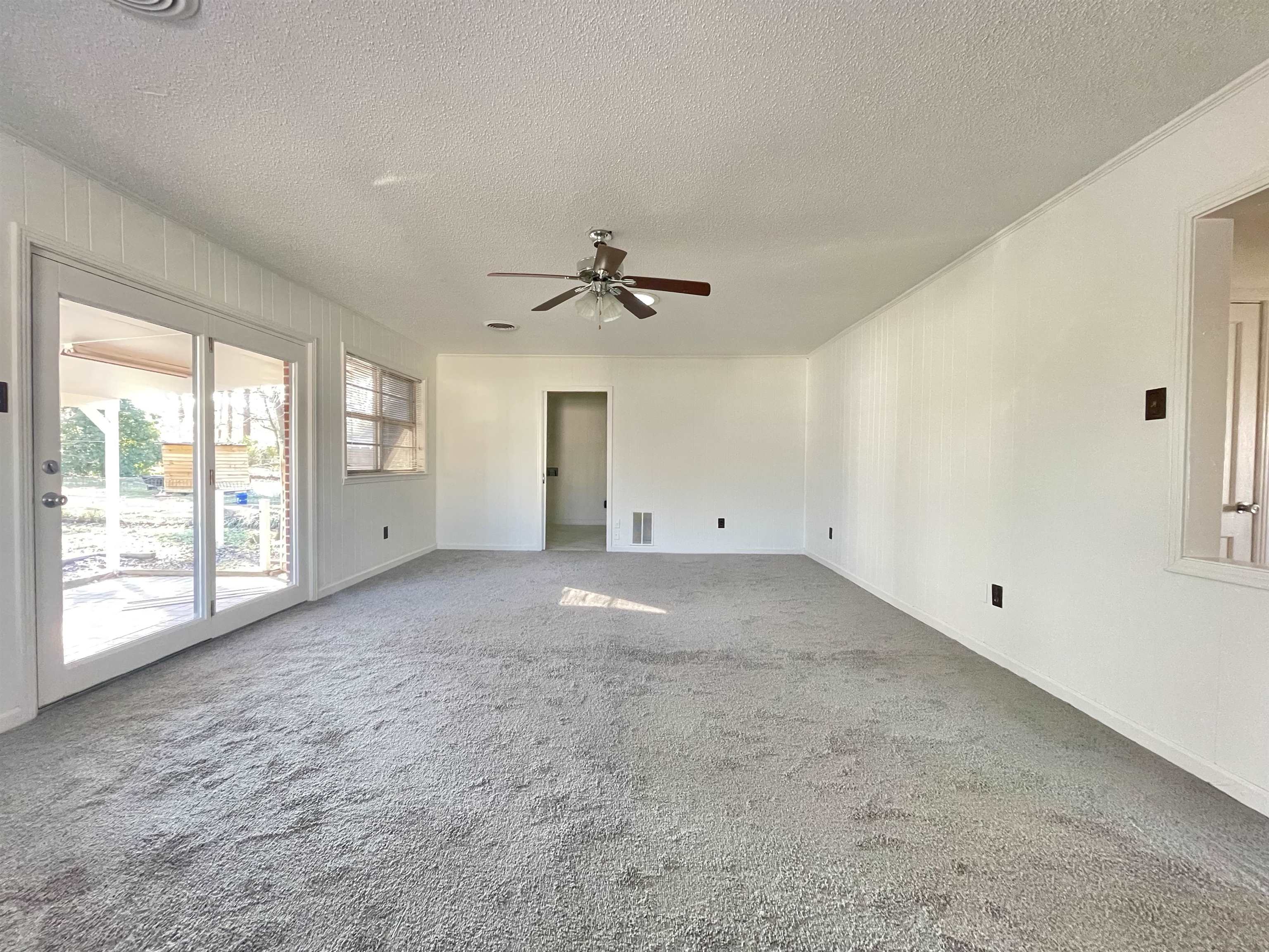 4691 Lynn Road Memphis, TN 38122 - Photo 7 of 12 a view of a livingroom with a ceiling fan and window
