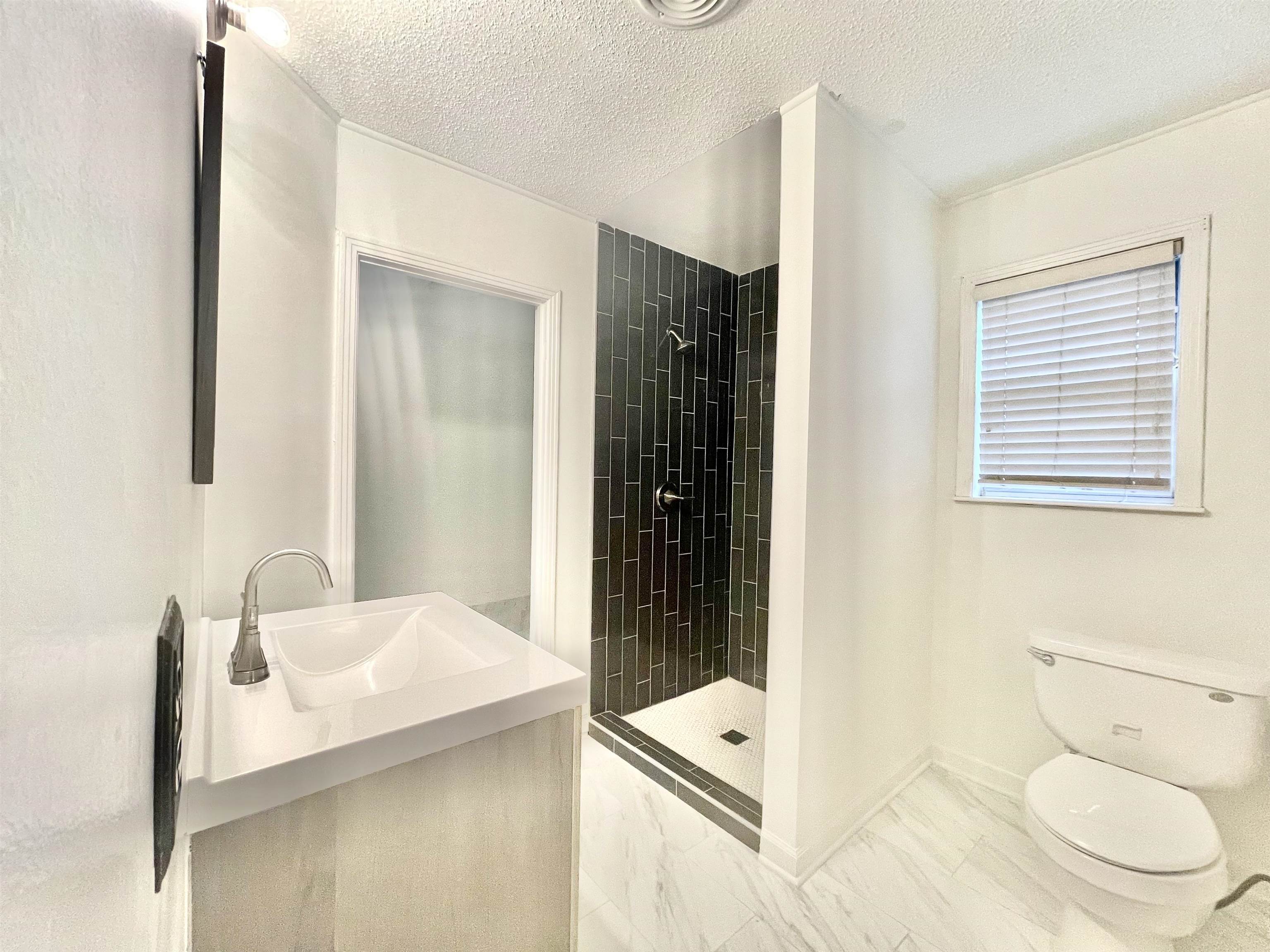 4691 Lynn Road Memphis, TN 38122 - Photo 8 of 12 a bathroom with a sink toilet and shower