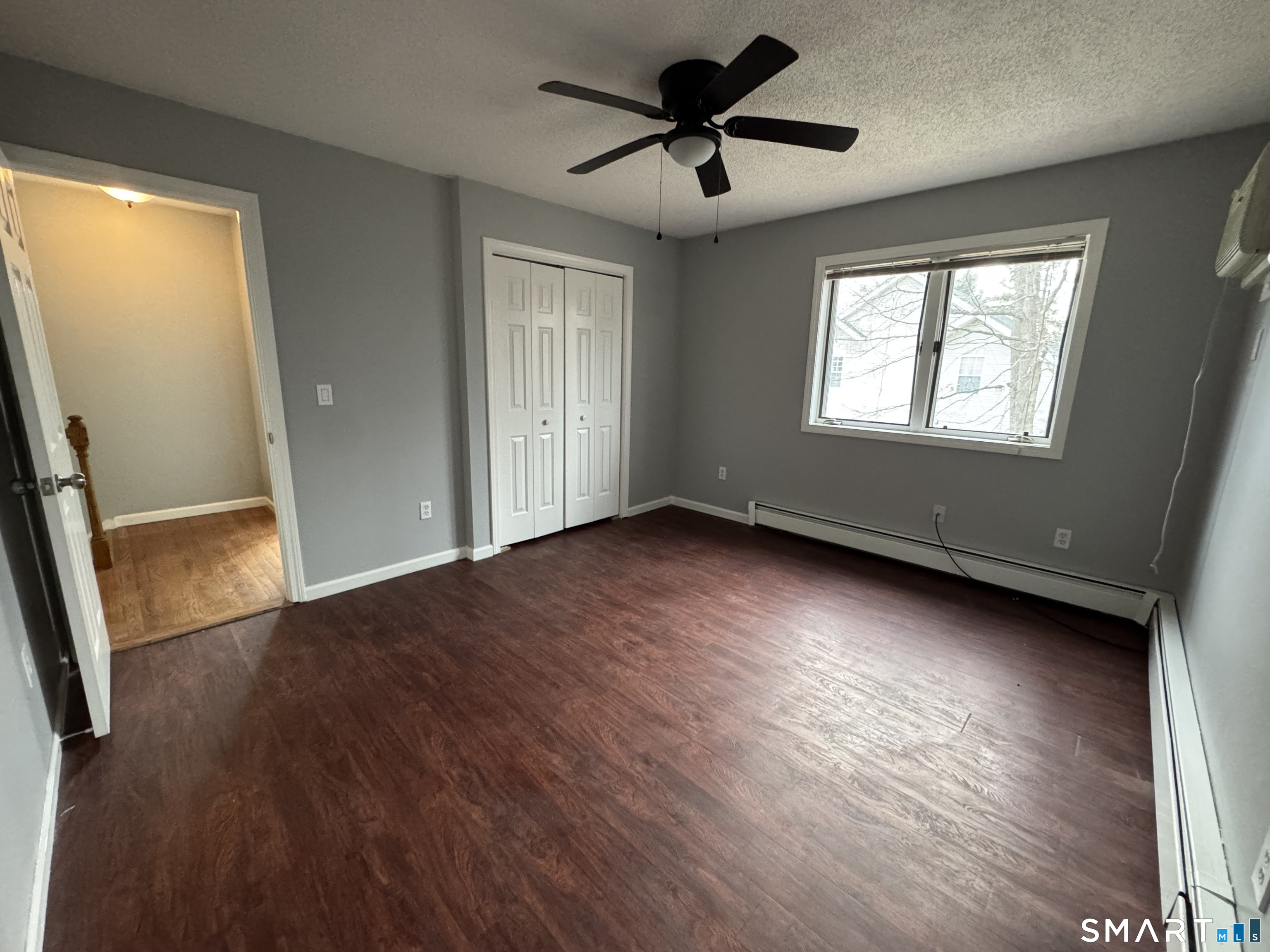27 Katie Lane Waterbury, CT 06708 - Photo 10 of 14 a view of empty room with wooden floor and fan