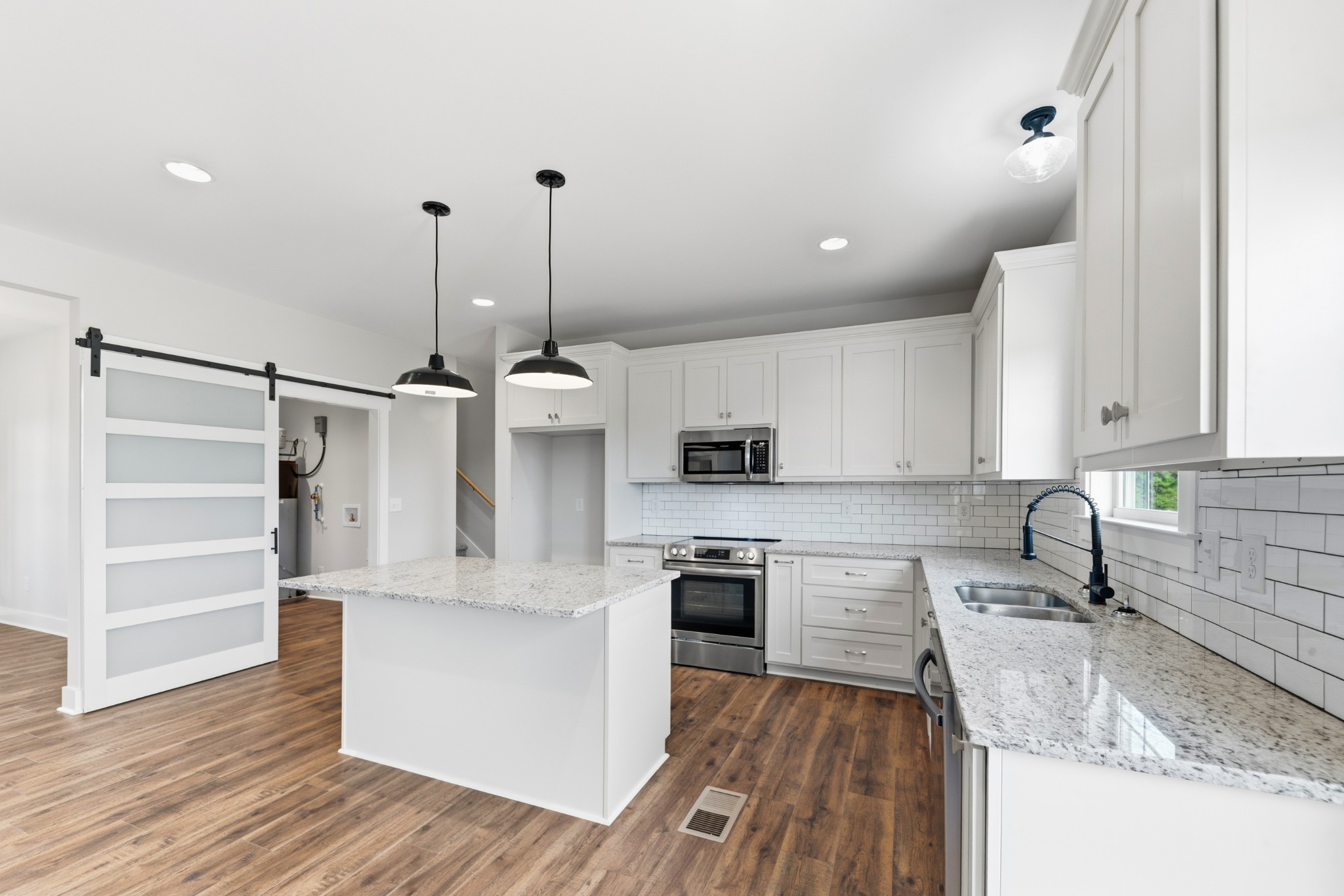 338 Dugout Road Summertown, TN 38483 - Photo 27 of 75 a kitchen with stainless steel appliances granite countertop a sink a stove and a wooden floors