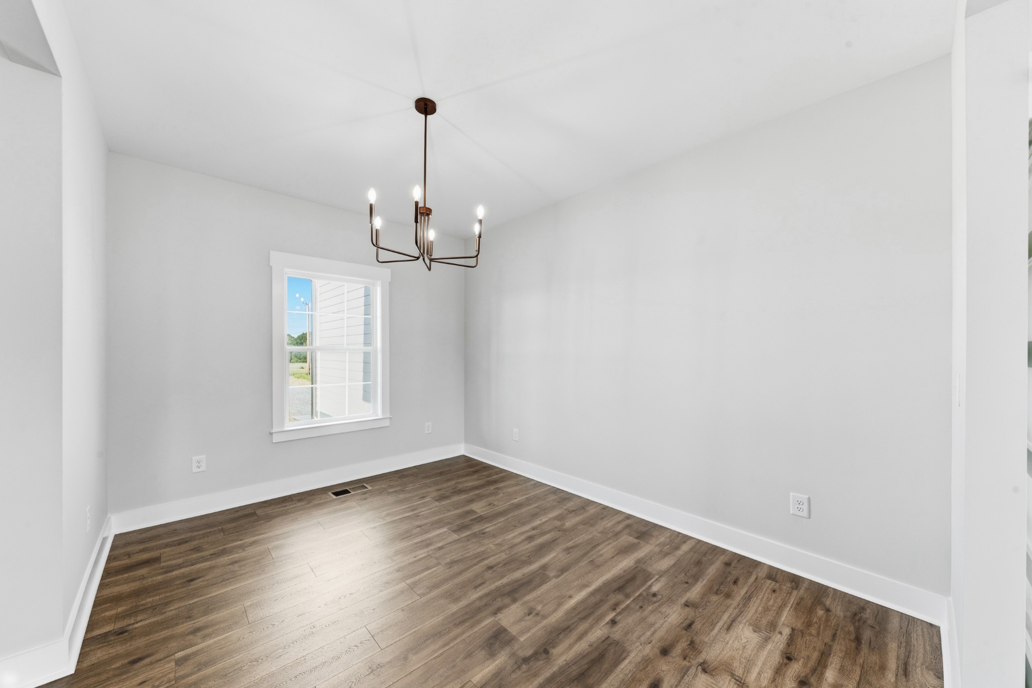 338 Dugout Road Summertown, TN 38483 - Photo 40 of 75 a view of empty room with wooden floor and fan