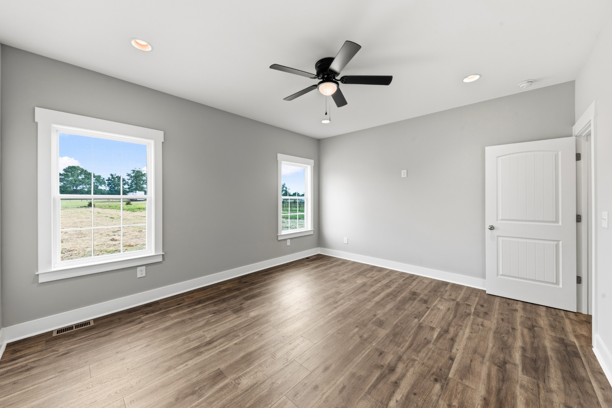 338 Dugout Road Summertown, TN 38483 - Photo 51 of 75 a view of an empty room with wooden floor and a window