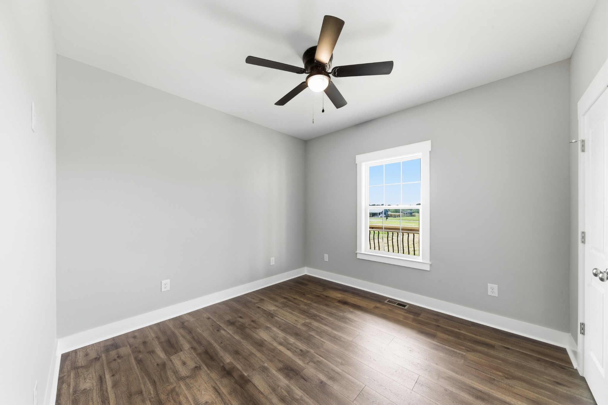 338 Dugout Road Summertown, TN 38483 - Photo 58 of 75 a view of empty room with wooden floor and ceiling fan