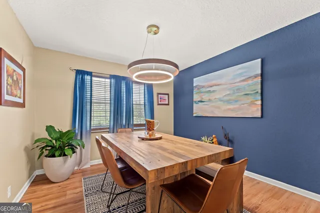 a view of a dining room with furniture and wooden floor