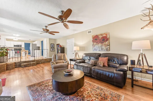 a living room with furniture a fireplace and a flat screen tv
