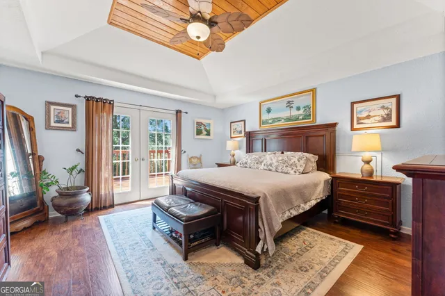a bedroom with furniture and a flat screen tv