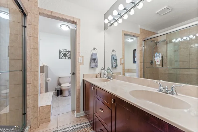 a white toilet sitting next to a bathroom sink and tub