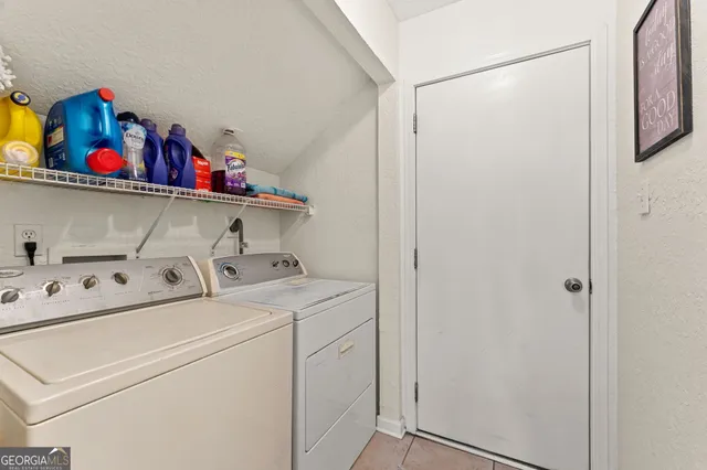 a view of a patio with table and chairs potted plants and large tree