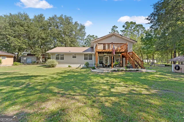 a view of a house with a yard and tree