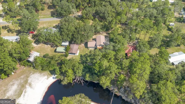 an aerial view of a house with a yard and outdoor seating