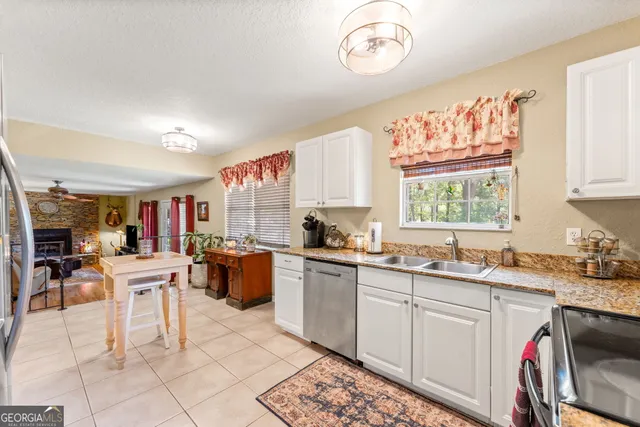 a bedroom with a bed and a large mirror on the dresser