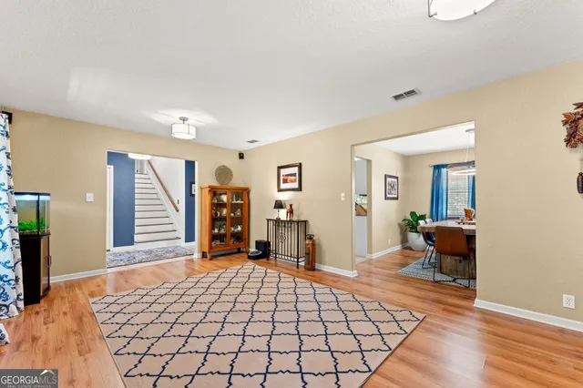 a bedroom with furniture and a flat screen tv