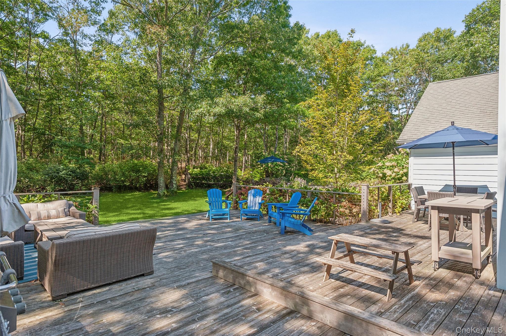 14 Hildreth Road Hampton Bays, NY 11946 - Photo 21 of 29 Wooden terrace with outdoor lounge area and outdoor dining space