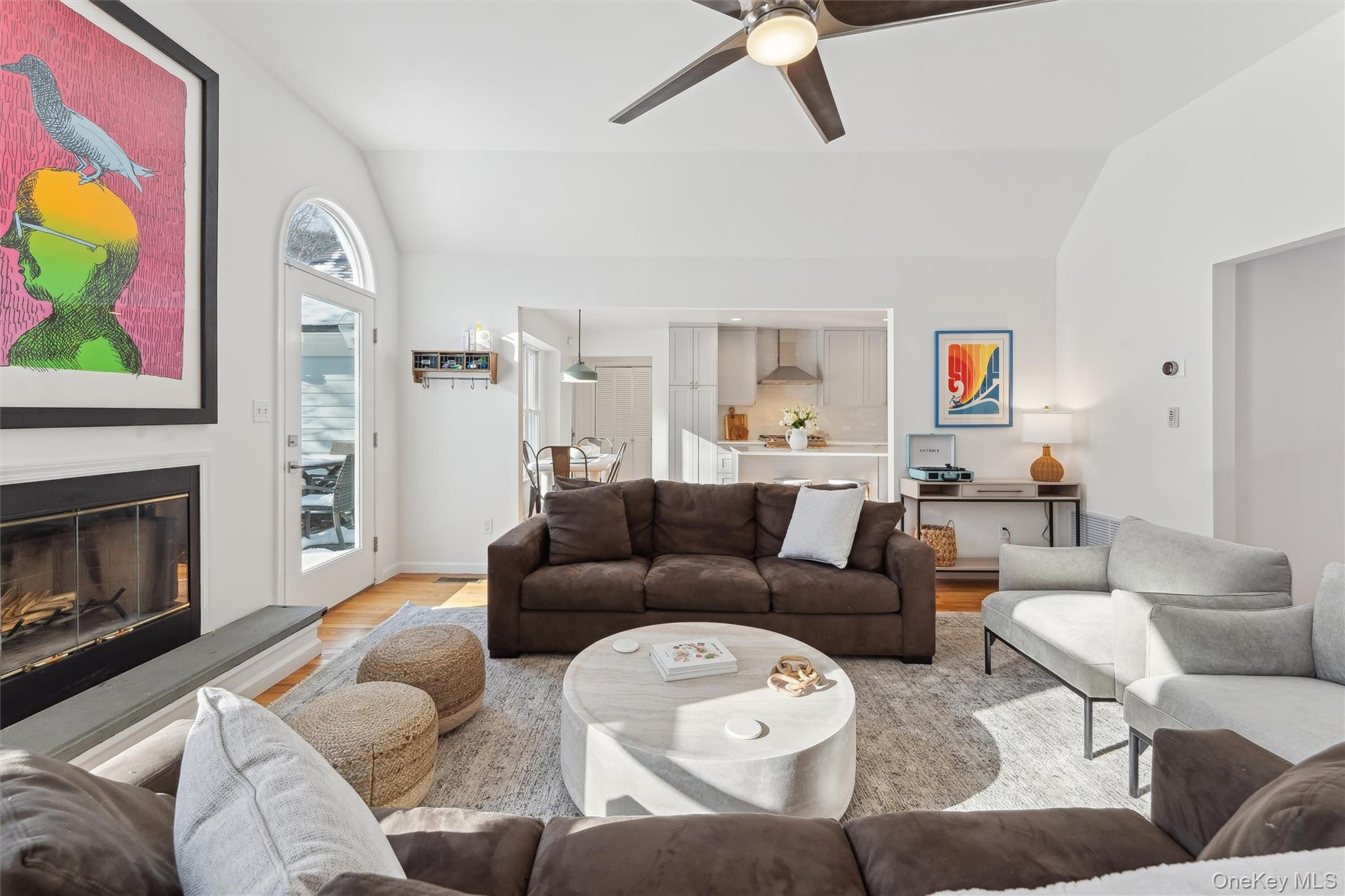 14 Hildreth Road Hampton Bays, NY 11946 - Photo 4 of 29 Living room featuring vaulted ceiling, wood floors, fireplace, and ceiling fan