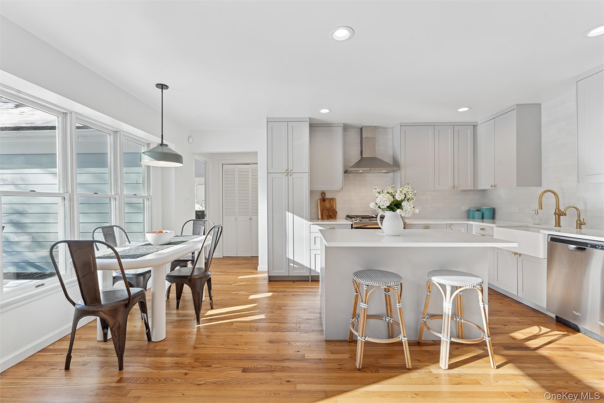 14 Hildreth Road Hampton Bays, NY 11946 - Photo 8 of 29 Kitchen with light countertops, a kitchen island, dishwasher, and light wood floors