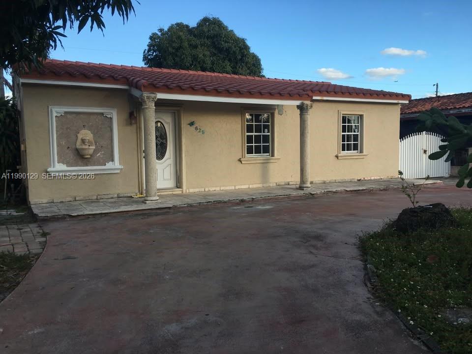 625 East 8th Court Hialeah, FL 33010 - Photo 1 of 18 a front view of a house with a yard